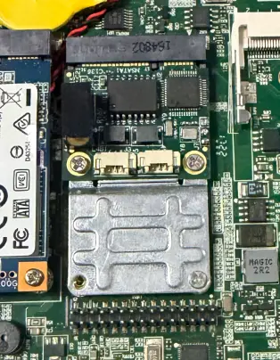 Close-up of the Dual CAN FD module gold fingers seated in the Mini PCIe connector and secured by two screws